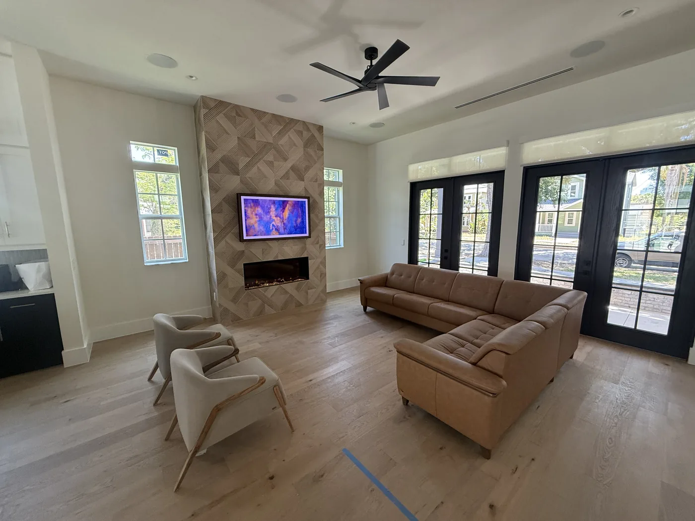 Living room with a tiled fireplace surround and wide-plank wood flooring